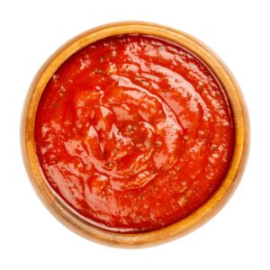 Arrabbiata sauce, spicy Italian tomato sauce in a wooden bowl